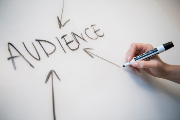 Writing in whiteboard with pointed arrows to the word 'Audience'